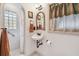 Charming bathroom features an arched doorway, shower, vessel sink and unique mirror at 251 72Nd Ave, St Pete Beach, FL 33706