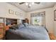 Well-lit bedroom with a ceiling fan, neutral walls, and a large bed with built-in headboard storage at 251 72Nd Ave, St Pete Beach, FL 33706