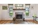 Bright living room area featuring fireplace with stone surround, mantle, and decorative accents at 251 72Nd Ave, St Pete Beach, FL 33706