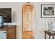 Hallway featuring hardwood floors, arched entryway, and neutral wall colors at 251 72Nd Ave, St Pete Beach, FL 33706