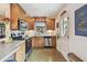 Eat-in kitchen offers stainless steel appliances, stone countertops, wood cabinets, and a door to the back at 251 72Nd Ave, St Pete Beach, FL 33706