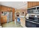 Updated kitchen featuring stainless steel appliances, stone countertops, and wood cabinetry that flows into the living room at 251 72Nd Ave, St Pete Beach, FL 33706