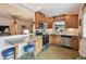 Updated kitchen featuring stainless steel appliances, stone countertops, wood cabinetry, and seating at 251 72Nd Ave, St Pete Beach, FL 33706