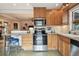 Updated kitchen featuring stainless steel appliances, stone countertops, wood cabinetry, and seating at 251 72Nd Ave, St Pete Beach, FL 33706