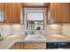 Bright kitchen with stone counters, stainless steel appliances, a kitchen window, and ample lighting at 251 72Nd Ave, St Pete Beach, FL 33706
