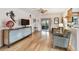 Open living room featuring hardwood floors, modern cabinet, ceiling fan, and sliding door access to the lanai at 251 72Nd Ave, St Pete Beach, FL 33706