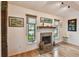 Cozy living room with a stone fireplace, wood mantle, decorative art, and beautiful natural light at 251 72Nd Ave, St Pete Beach, FL 33706