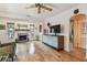 Spacious living room with hardwood floors, stone fireplace, modern cabinets, and natural light at 251 72Nd Ave, St Pete Beach, FL 33706