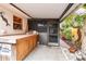 Outdoor bar area with a tiled countertop, seating, and access to a screened enclosure, perfect for entertaining at 251 72Nd Ave, St Pete Beach, FL 33706
