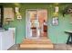 Covered porch featuring sliding glass door and three steps leading to inside the home at 251 72Nd Ave, St Pete Beach, FL 33706
