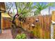 Landscaped side yard showcasing a decorative fence, potted plants, and lush foliage, adding charm to the property at 251 72Nd Ave, St Pete Beach, FL 33706