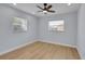 Bright bedroom featuring wood-look floors and a modern ceiling fan at 2801 Poinciana Ct, Punta Gorda, FL 33950