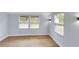 Bright bedroom features fresh paint, modern light fixtures, and wood-look flooring at 2801 Poinciana Ct, Punta Gorda, FL 33950