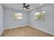 Well lit bedroom featuring wood-look floors and a modern ceiling fan at 2801 Poinciana Ct, Punta Gorda, FL 33950