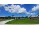 A single story home with green lawn, blue sky and wispy clouds at 2801 Poinciana Ct, Punta Gorda, FL 33950