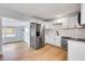 Modern kitchen offering stainless steel appliances and white cabinets, seamlessly connected to a cozy dining area at 2801 Poinciana Ct, Punta Gorda, FL 33950