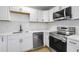 Bright kitchen with white cabinets, stainless steel appliances, and modern fixtures, ready for culinary adventures at 2801 Poinciana Ct, Punta Gorda, FL 33950