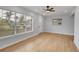 Living room with wood-look flooring, and large window with front door at 2801 Poinciana Ct, Punta Gorda, FL 33950