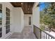 A covered balcony with stone flooring, wood ceiling, and a metal railing overlooking lush greenery at 3406 W Alline Ave, Tampa, FL 33611