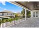 This balcony has a stone tile floor, black metal railing, and gorgeous views of the neighborhood at 3406 W Alline Ave, Tampa, FL 33611