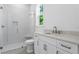 Bright bathroom featuring white cabinets, marble countertop and tiled shower at 3406 W Alline Ave, Tampa, FL 33611