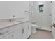 Modern bathroom features a vanity with chrome fixtures and a glass enclosed shower with white tiling at 3406 W Alline Ave, Tampa, FL 33611