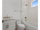 Modern bathroom with a white vanity, toilet, and shower/tub combo with neutral tiling at 3406 W Alline Ave, Tampa, FL 33611