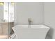 Spa-like bathroom with a modern soaking tub and elegant fixtures at 3406 W Alline Ave, Tampa, FL 33611