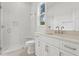 Bright bathroom featuring herringbone tile shower, stone countertop vanity, and glass shower door at 3406 W Alline Ave, Tampa, FL 33611