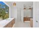 Bathroom with a long double sink, white countertop, and decorative lights at 3406 W Alline Ave, Tampa, FL 33611