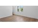 Bright bedroom with light hardwood floors and a large window offering natural light at 3406 W Alline Ave, Tampa, FL 33611