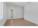 Spacious bedroom with light hardwood flooring and a glass door leading to an outdoor balcony at 3406 W Alline Ave, Tampa, FL 33611