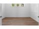 Bright bedroom with hardwood floors, white walls, and natural light from three windows at 3406 W Alline Ave, Tampa, FL 33611