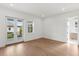 This bedroom has wood floors, white walls, double doors leading to a balcony, and a bright window at 3406 W Alline Ave, Tampa, FL 33611