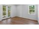Well-lit room with french doors to the balcony and gleaming hardwood floors at 3406 W Alline Ave, Tampa, FL 33611