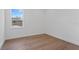Bright bedroom with light hardwood floors and a window with a view to the outside at 3406 W Alline Ave, Tampa, FL 33611