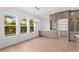 Bright dining area featuring hardwood floors, built-in cabinets, and large windows with a view at 3406 W Alline Ave, Tampa, FL 33611