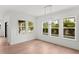 Bright dining area with wood floors, modern chandelier, and large windows overlooking the pool at 3406 W Alline Ave, Tampa, FL 33611