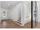 Welcoming entryway with hardwood floors, stairs, and modern wine rack near the front door at 3406 W Alline Ave, Tampa, FL 33611