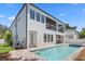 Exterior view of the house showing the pool area with an outdoor kitchen and second story covered deck at 3406 W Alline Ave, Tampa, FL 33611