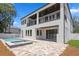Exterior view showcasing a covered balcony, modern design, and a private pool with spa at 3406 W Alline Ave, Tampa, FL 33611