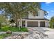 Charming two-story home featuring a three-car garage and balcony, all enhanced by lush landscaping at 3406 W Alline Ave, Tampa, FL 33611