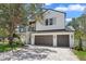 Beautiful two-story home boasting a three-car garage, accented by mature trees and manicured landscaping at 3406 W Alline Ave, Tampa, FL 33611