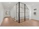 Bright entryway featuring modern staircase with glass enclosure and hardwood floors at 3406 W Alline Ave, Tampa, FL 33611