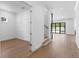 Hallway leading to the main living space with hardwood floors, modern door frames, and pool view at 3406 W Alline Ave, Tampa, FL 33611