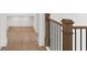 Hallway featuring hardwood floors, neutral walls, and a decorative railing at 3406 W Alline Ave, Tampa, FL 33611