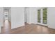 Bright hallway features light hardwood flooring and access to other rooms and exterior access via double doors at 3406 W Alline Ave, Tampa, FL 33611