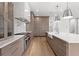 Open concept kitchen showcasing stainless steel range, custom cabinetry, and a large island at 3406 W Alline Ave, Tampa, FL 33611