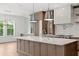 Close up shot of kitchen island with stainless steel appliances and a marble backsplash at 3406 W Alline Ave, Tampa, FL 33611