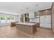 Open-concept kitchen featuring a central island, stainless steel appliances, and ample counter space at 3406 W Alline Ave, Tampa, FL 33611